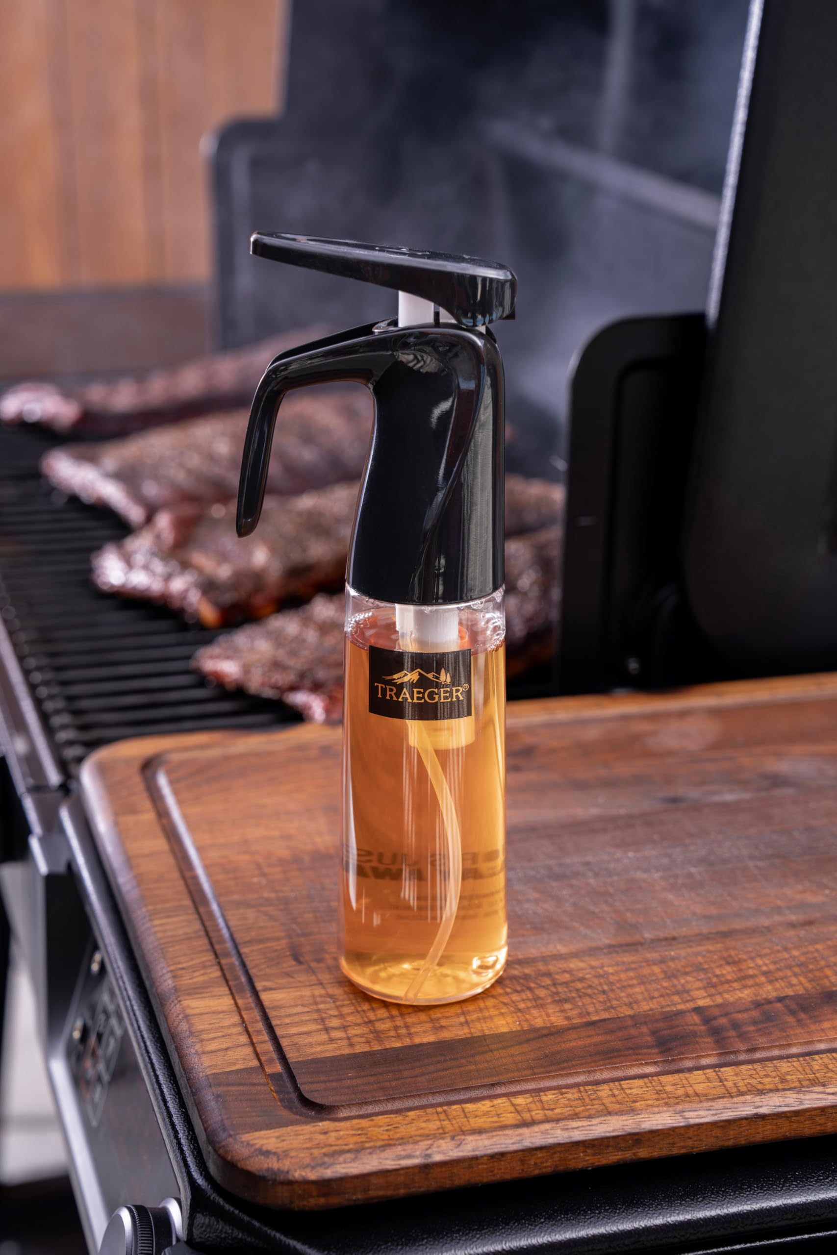 Traeger spritzer held in hand to show compact size and ergonomic grip