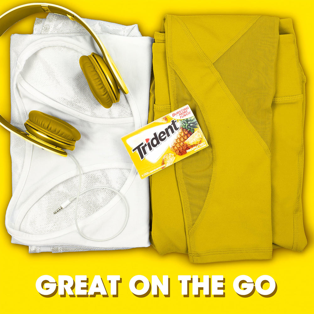 Trident gum next to fresh pineapple to emphasize tropical flavor