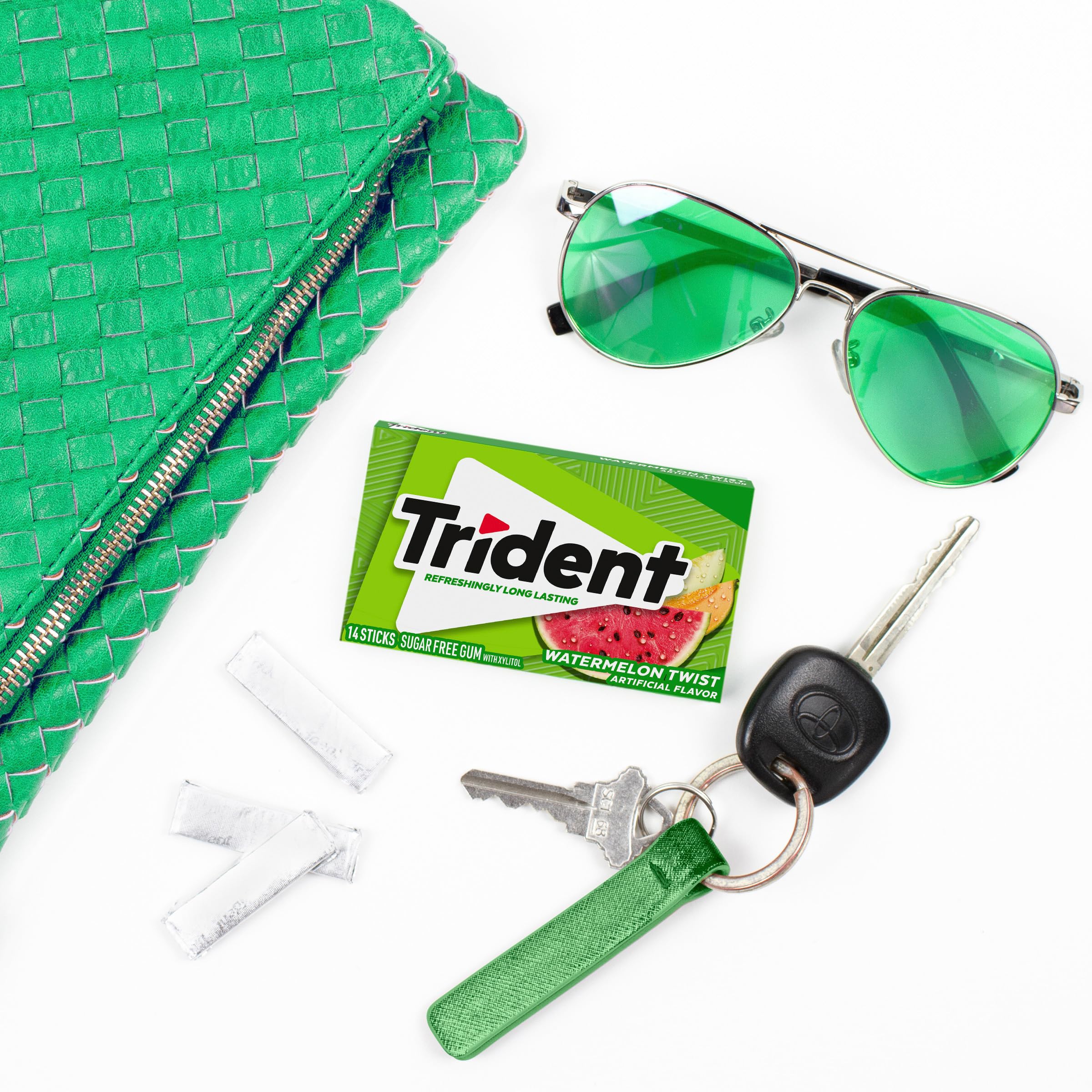 Hand holding Trident watermelon sticks demonstrating easy on-the-go access