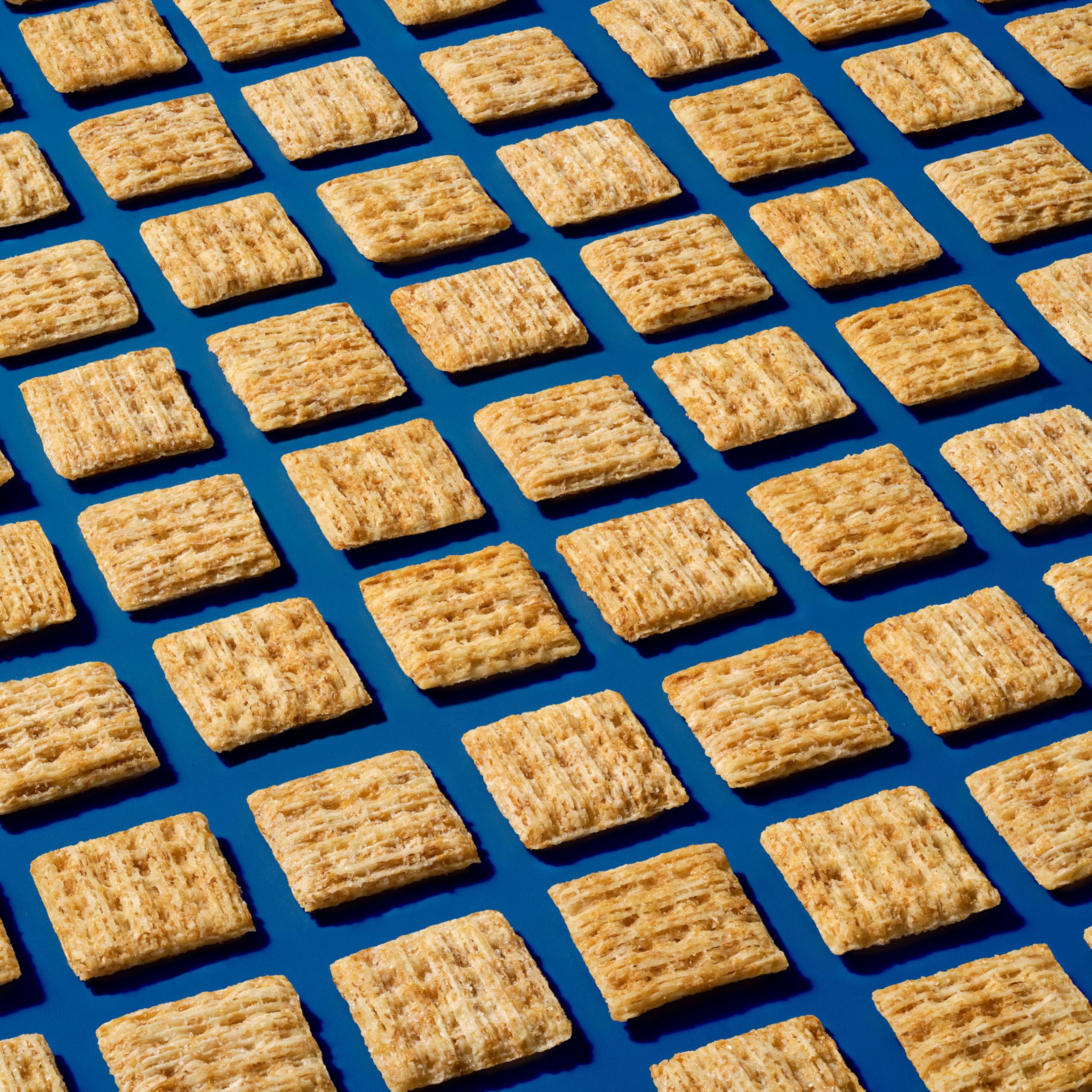 Hand holding Triscuit Minis for size comparison and easy portability