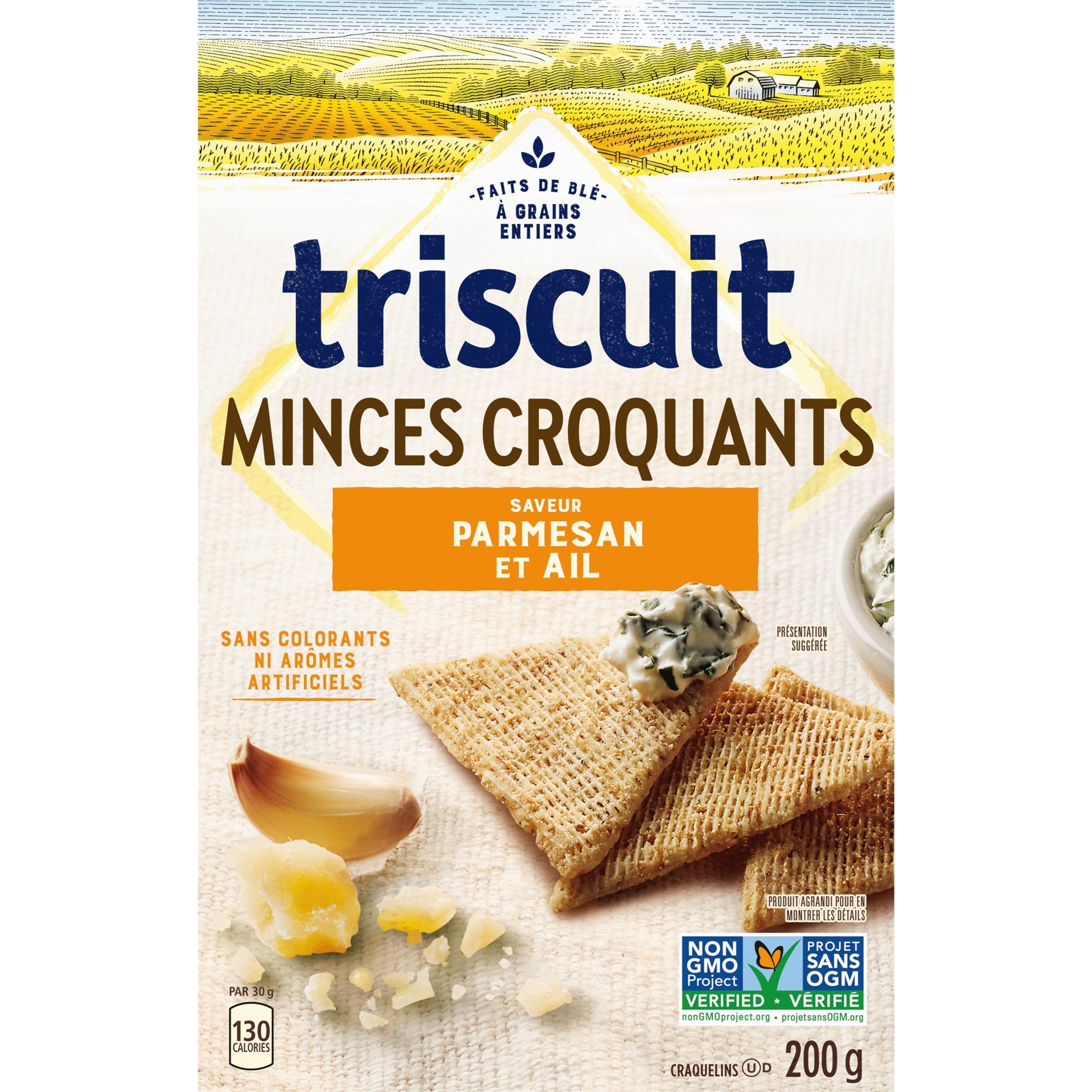 Hand holding a Triscuit Thin Crisp to show scale and easy, on-the-go snacking