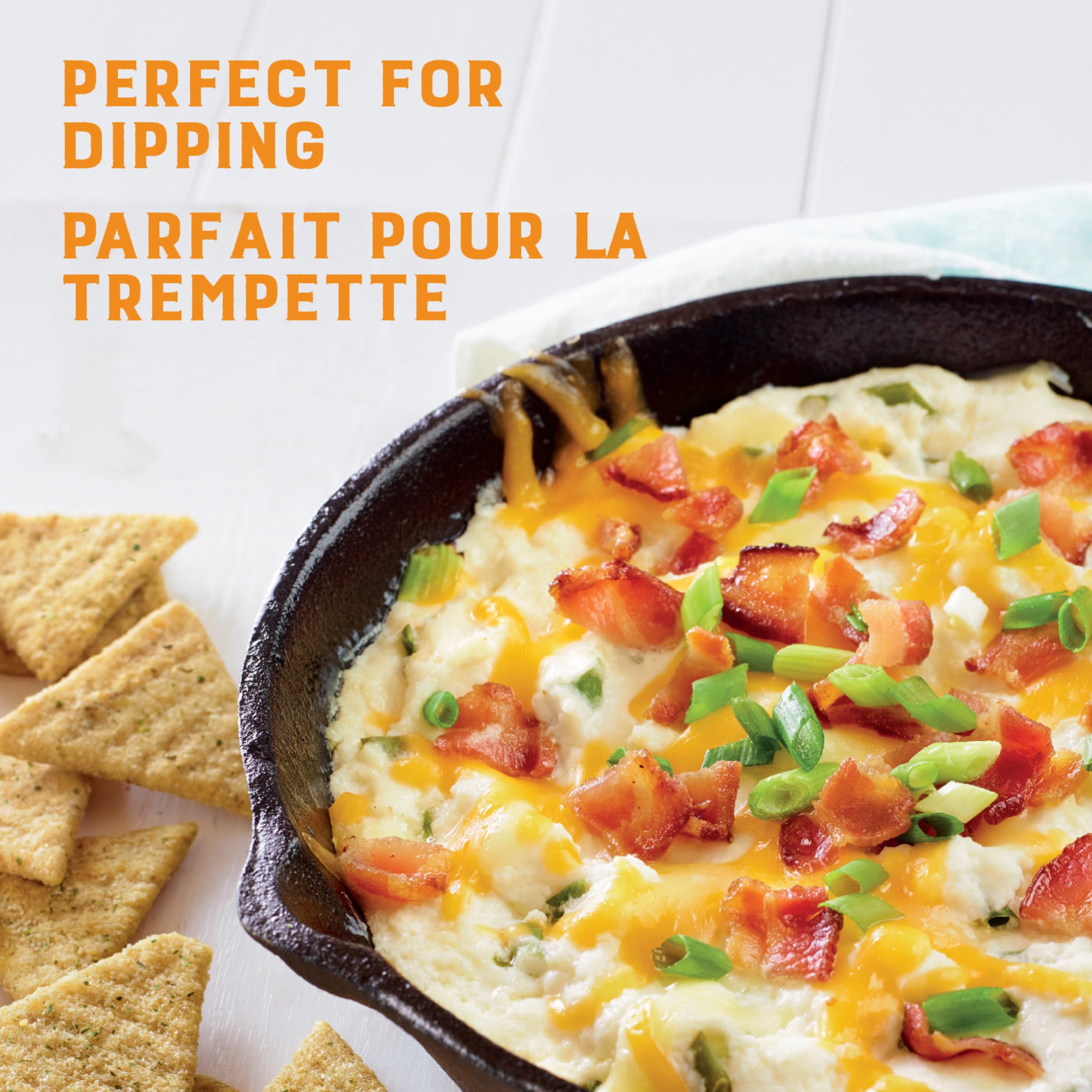 Triscuit cracker dipped into creamy spread demonstrating sturdy scoopability