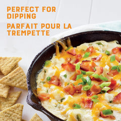 Triscuit cracker dipped into creamy spread demonstrating sturdy scoopability