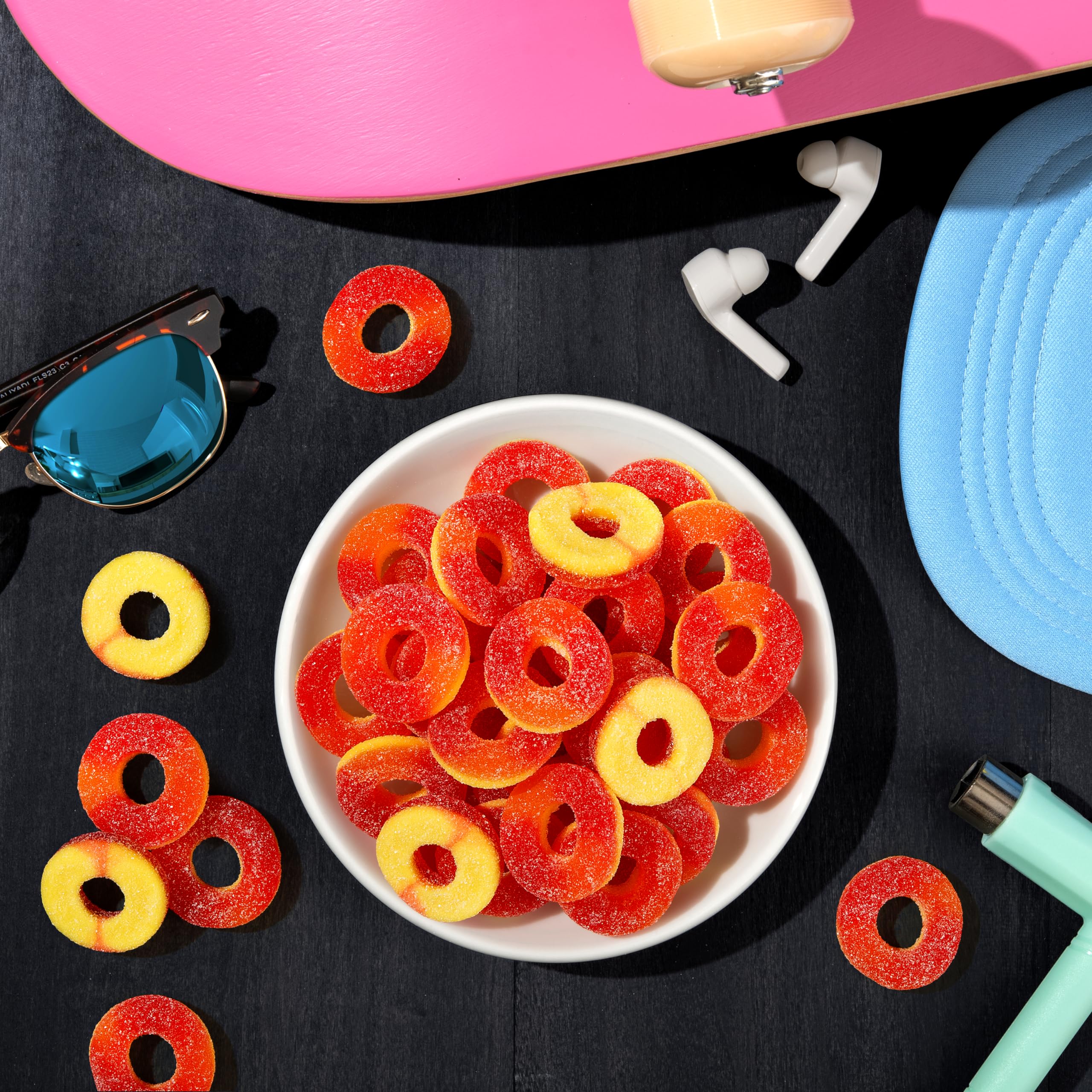 Hand holding Trolli Peachie O's to show scale and portion size for convenience