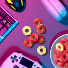 Hand holding a Trolli Peachie O's ring showing size and portion convenience
