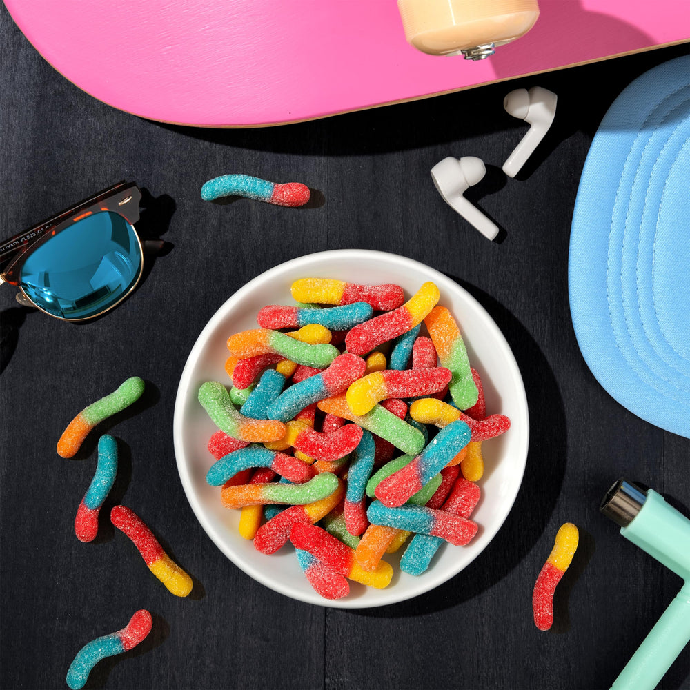 Trolli worms held in a hand to show scale and easy snacking portion