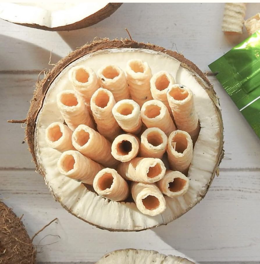 Tropical Fields coconut rolls served in a bowl beside coffee, convenient organic snacking benefit