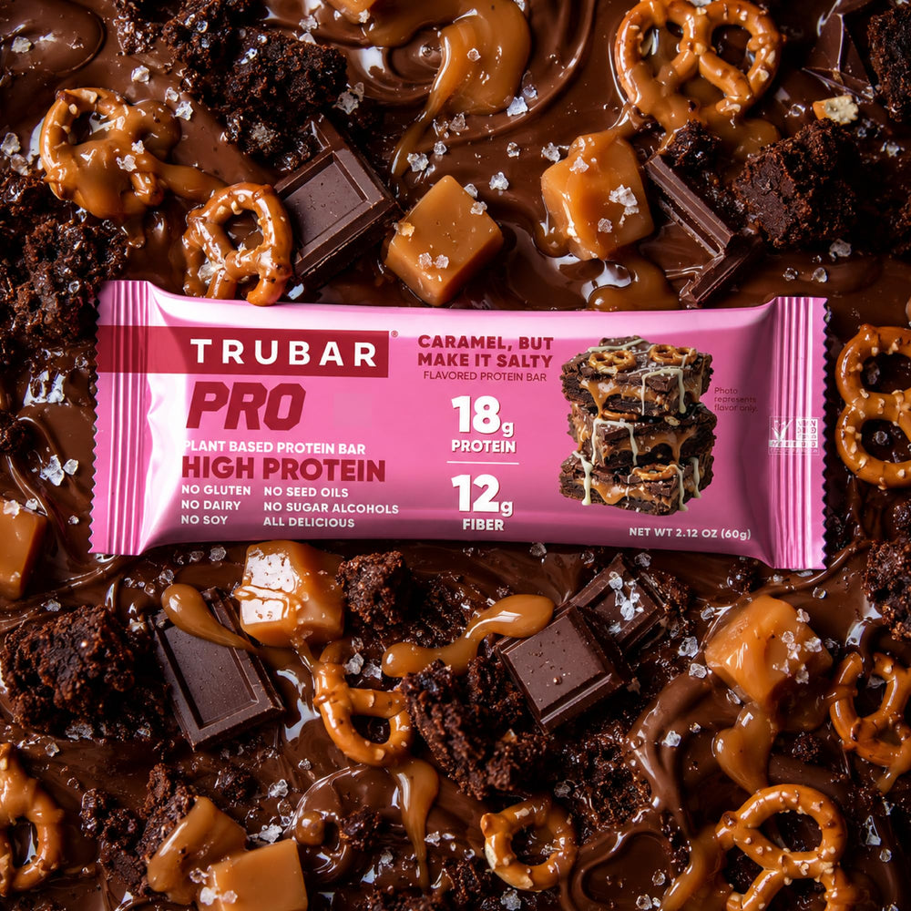 TRUBAR bar in hand demonstrating portable plant-based protein snack for on-the-go fueling