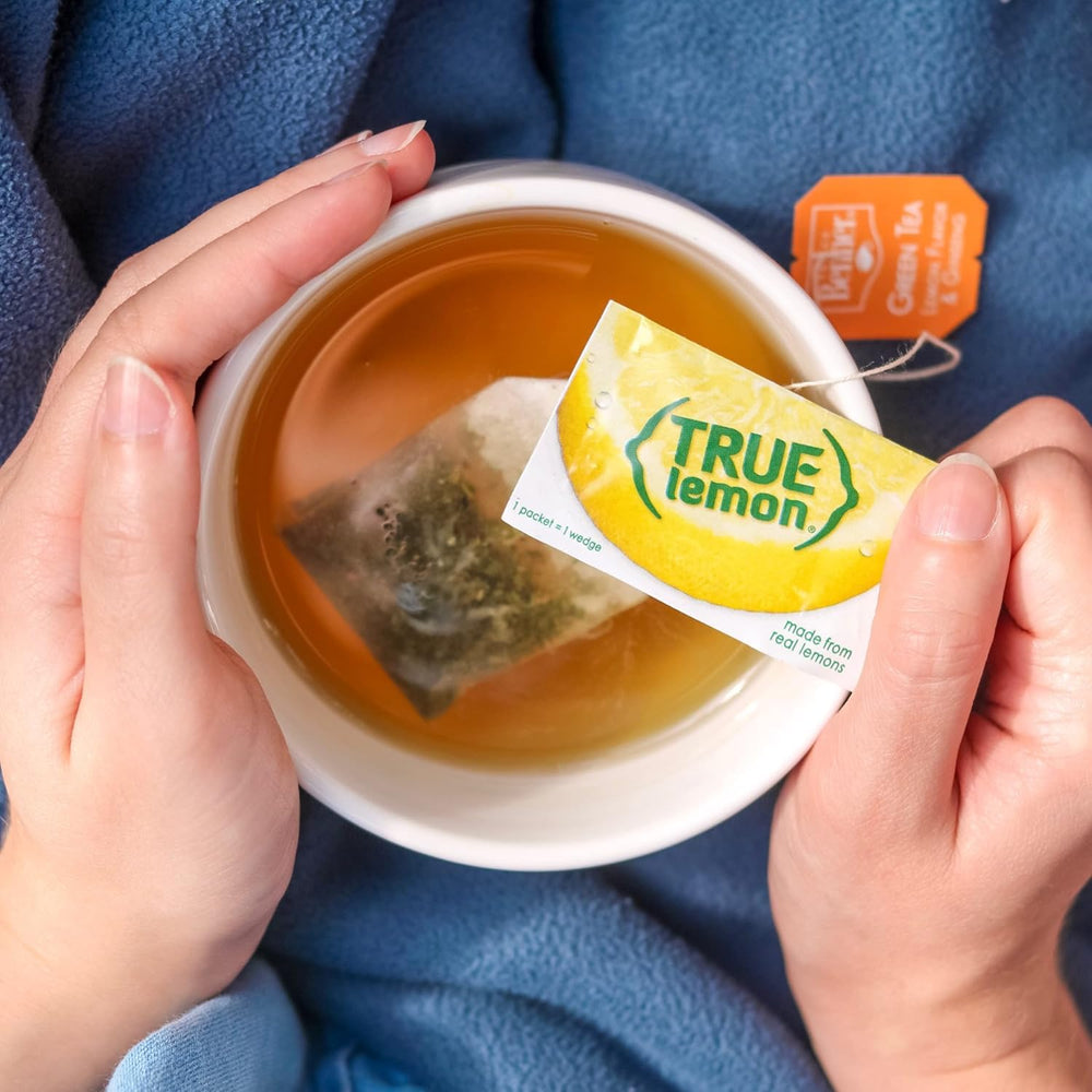 True Citrus packet beside a fresh lemon to show portion and concentrated convenience