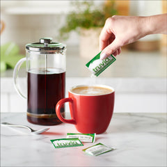 Truvia packet poured into coffee showing fast sweetening benefit