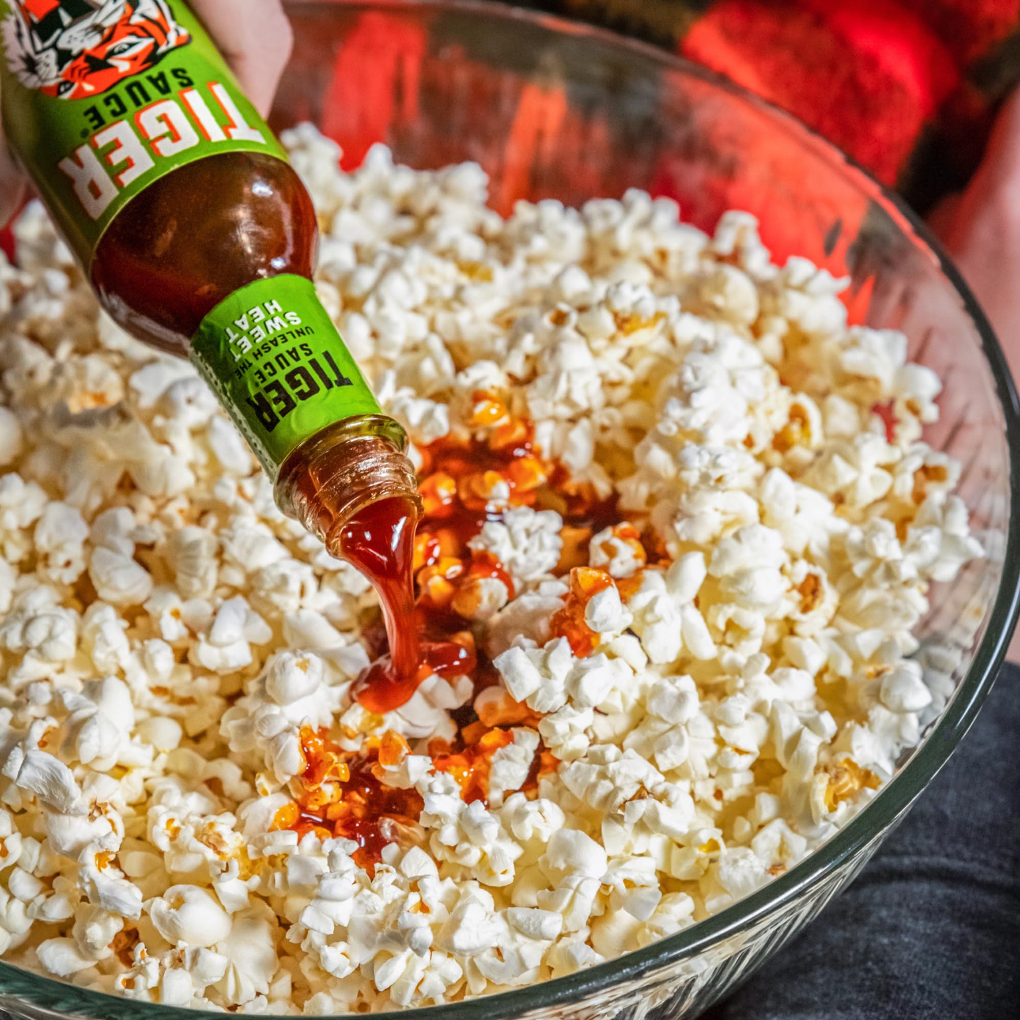 Try Me Tiger Sauce beside a measuring cup for scale, clarifying 5 fl oz bottle size