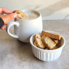 Tutti Gourmet open bag with biscotti on wooden board for serving