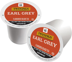 Hand holding a Twinings Earl Grey pod over a Keurig, showing no-mess single-serve convenience