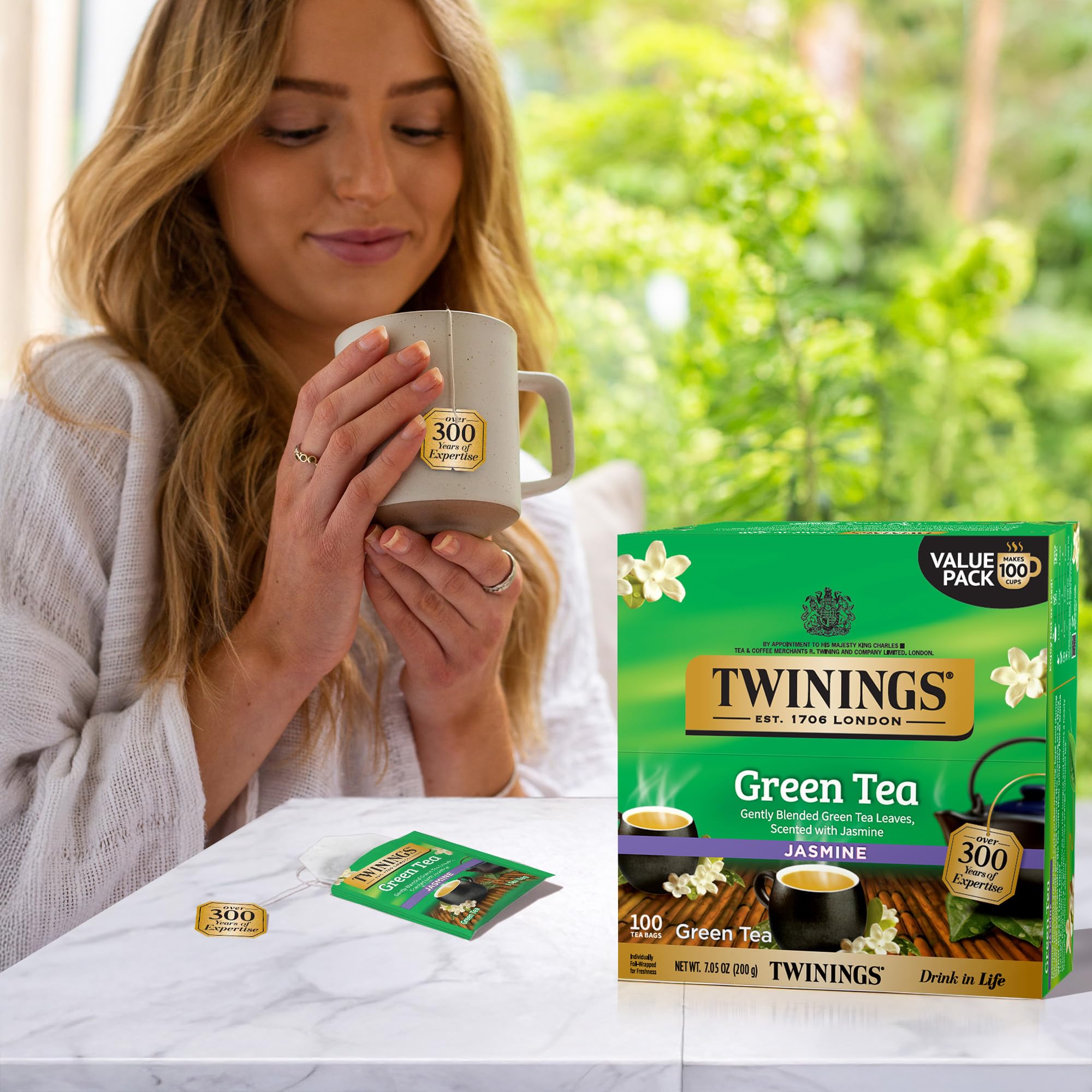 Close-up of Twinings green tea leaves and jasmine buds showing quality ingredients