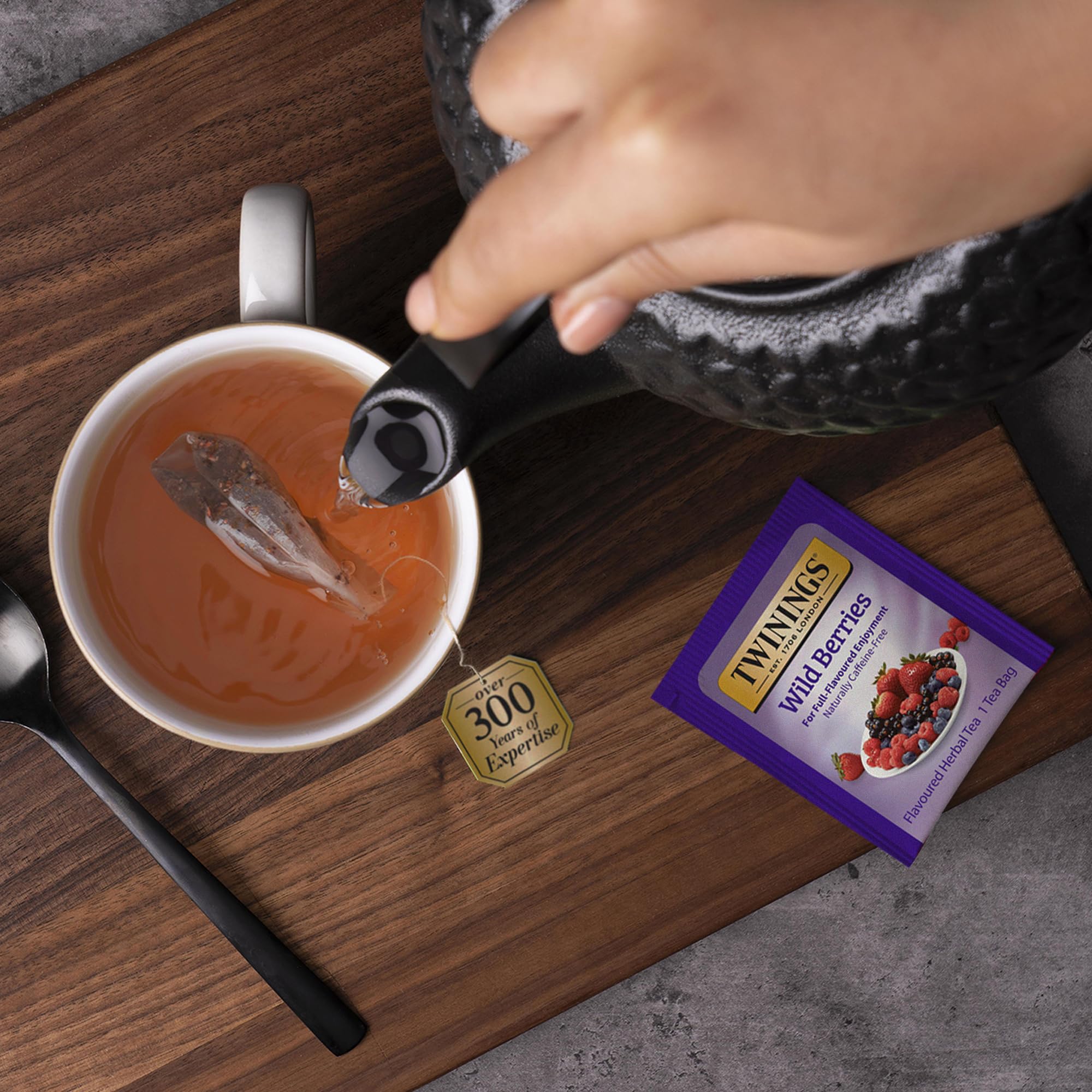 Hand holding Twinings box for scale illustrating portable size and pantry-friendly pack