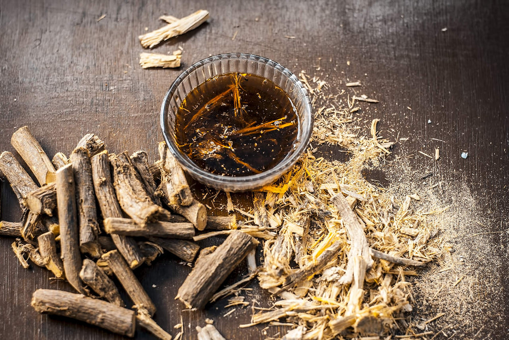 U.S. Wellness Naturals pouring brewed licorice tea from a teapot for serving