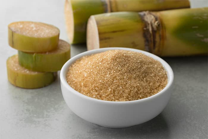 Unpretentious cane sugar staged with flour eggs and butter for baking convenience