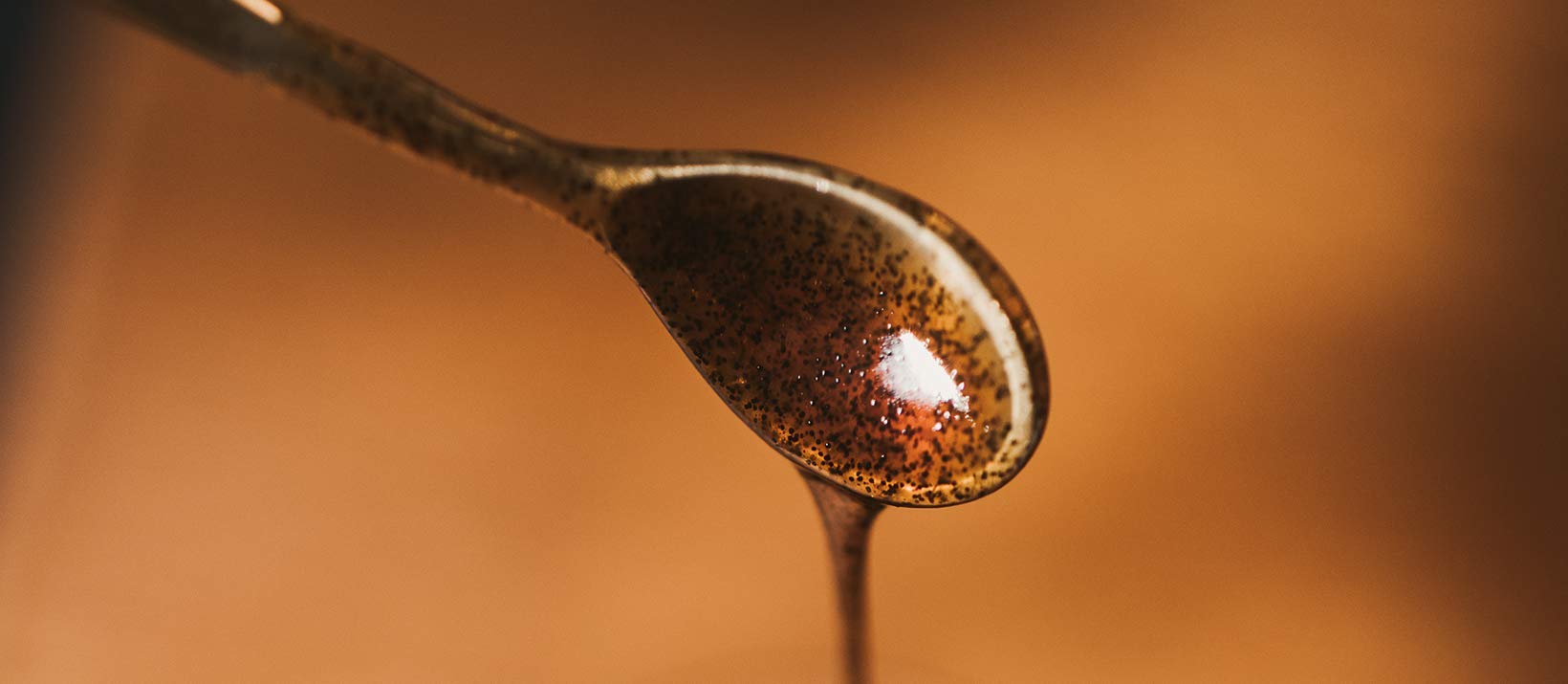 Measuring teaspoon of Vanilla Bean Kings paste for accurate recipe substitution