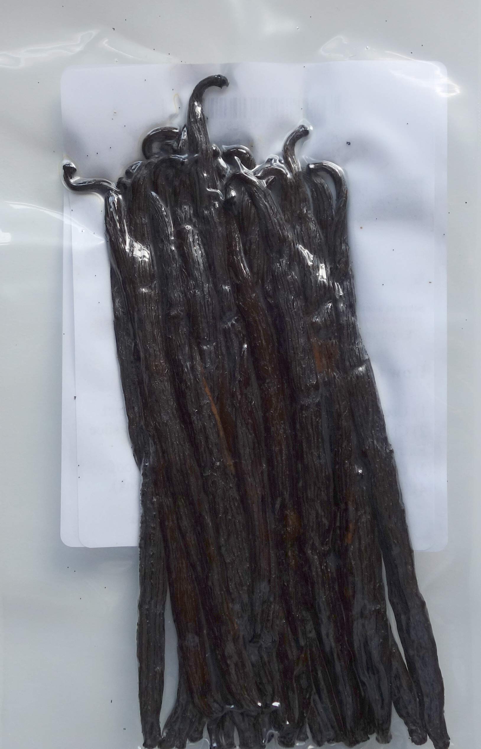 Close-up texture of Madagascar Bourbon pods showing seeds and rich oils for flavor
