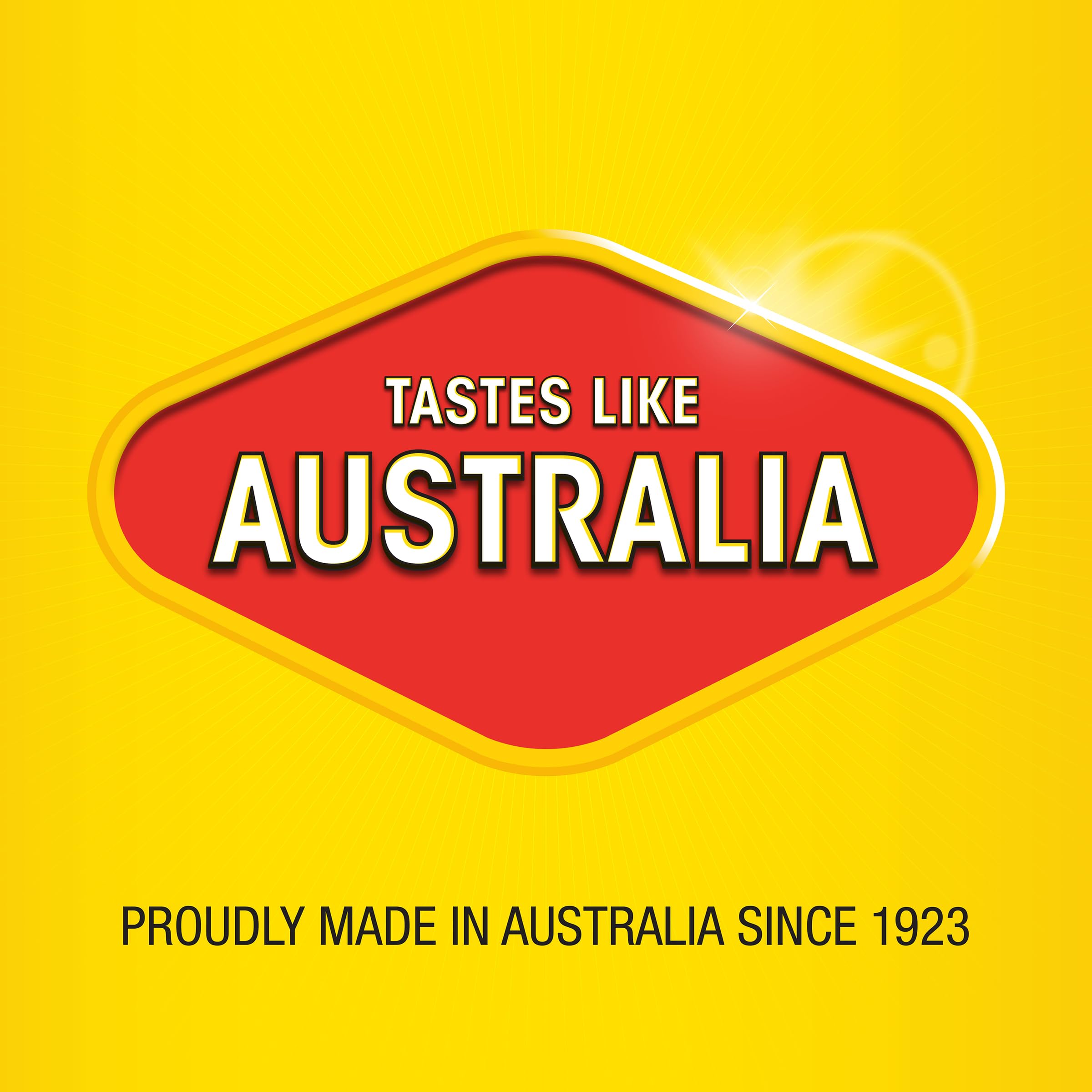 Vegemite Squeezy beside toast and hand for scale, illustrating portable 200g bottle