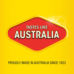 Vegemite Squeezy beside toast and hand for scale, illustrating portable 200g bottle