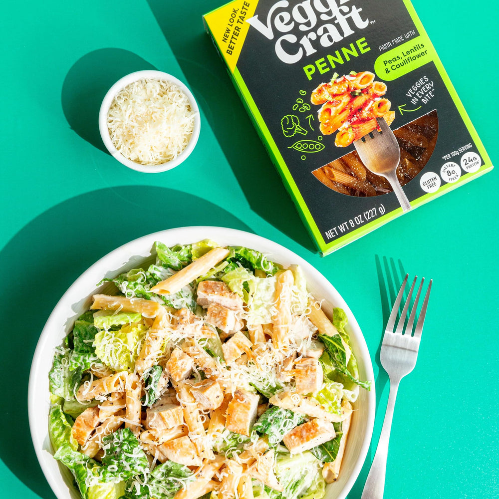 Veggiecraft Farms penne next to measuring cup illustrating serving size and portions