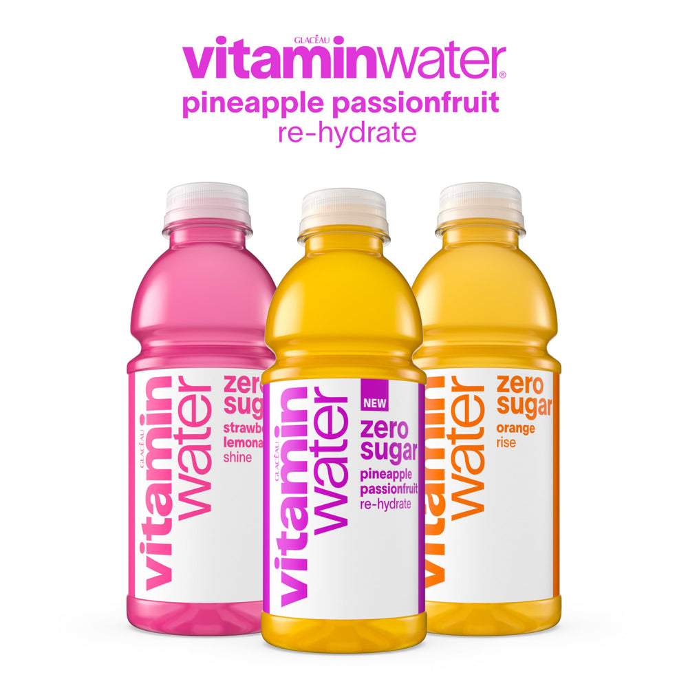 vitaminwater bottle beside a laptop showing desk refreshment convenience