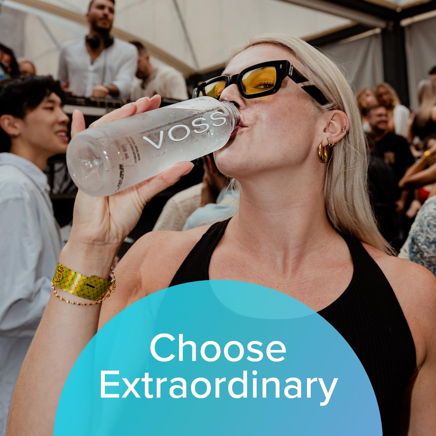 VOSS bottle poolside lifestyle scene conveying refreshment on-the-go