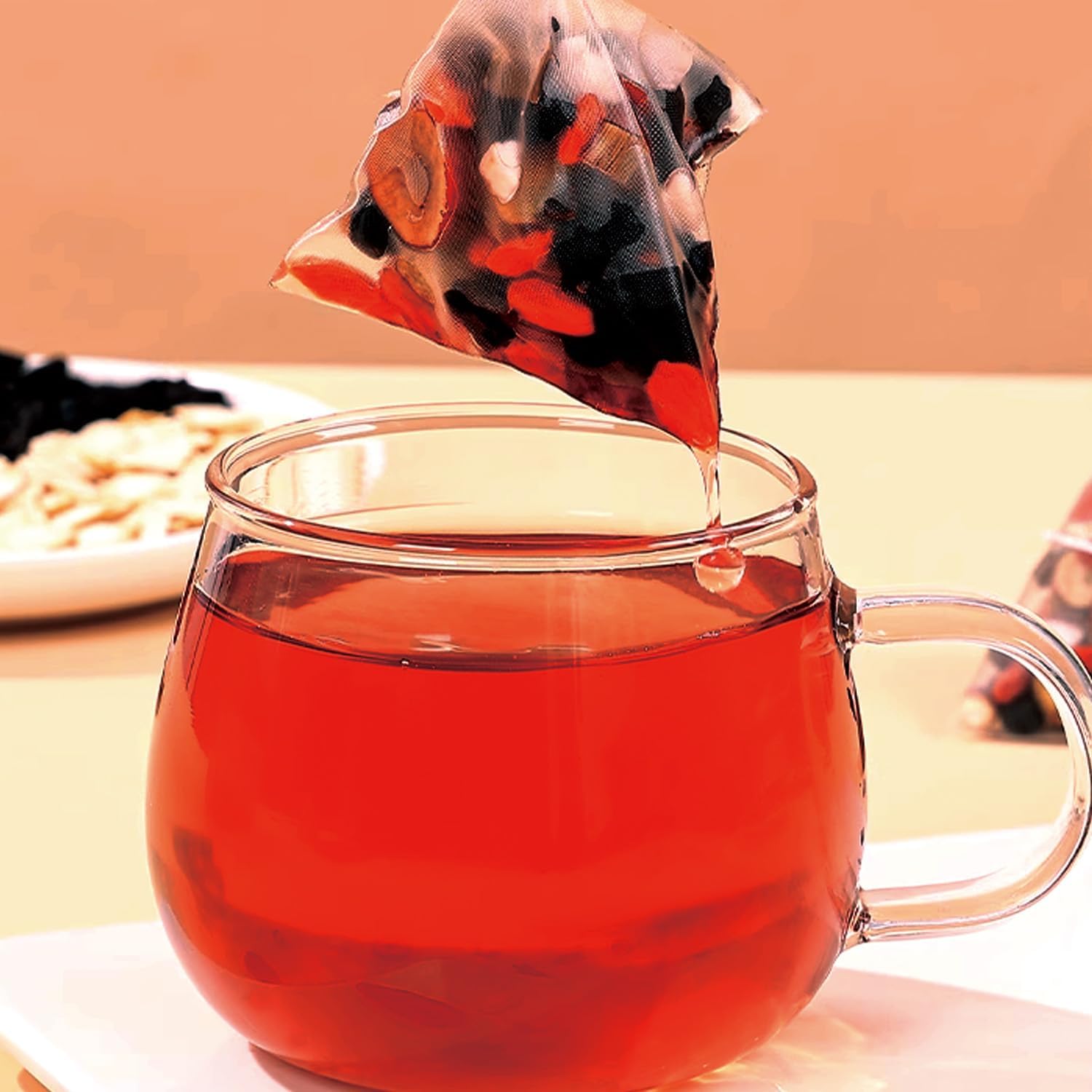 Wanciment teabag beside a ruler demonstrating teabag size and portion guidance