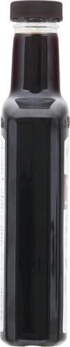 Watkins bottle beside Madagascar vanilla beans showing natural source benefit