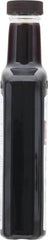 Watkins bottle beside Madagascar vanilla beans showing natural source benefit