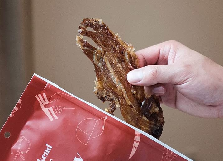 Weekend Jerky in hand for scale highlighting compact pouch convenience