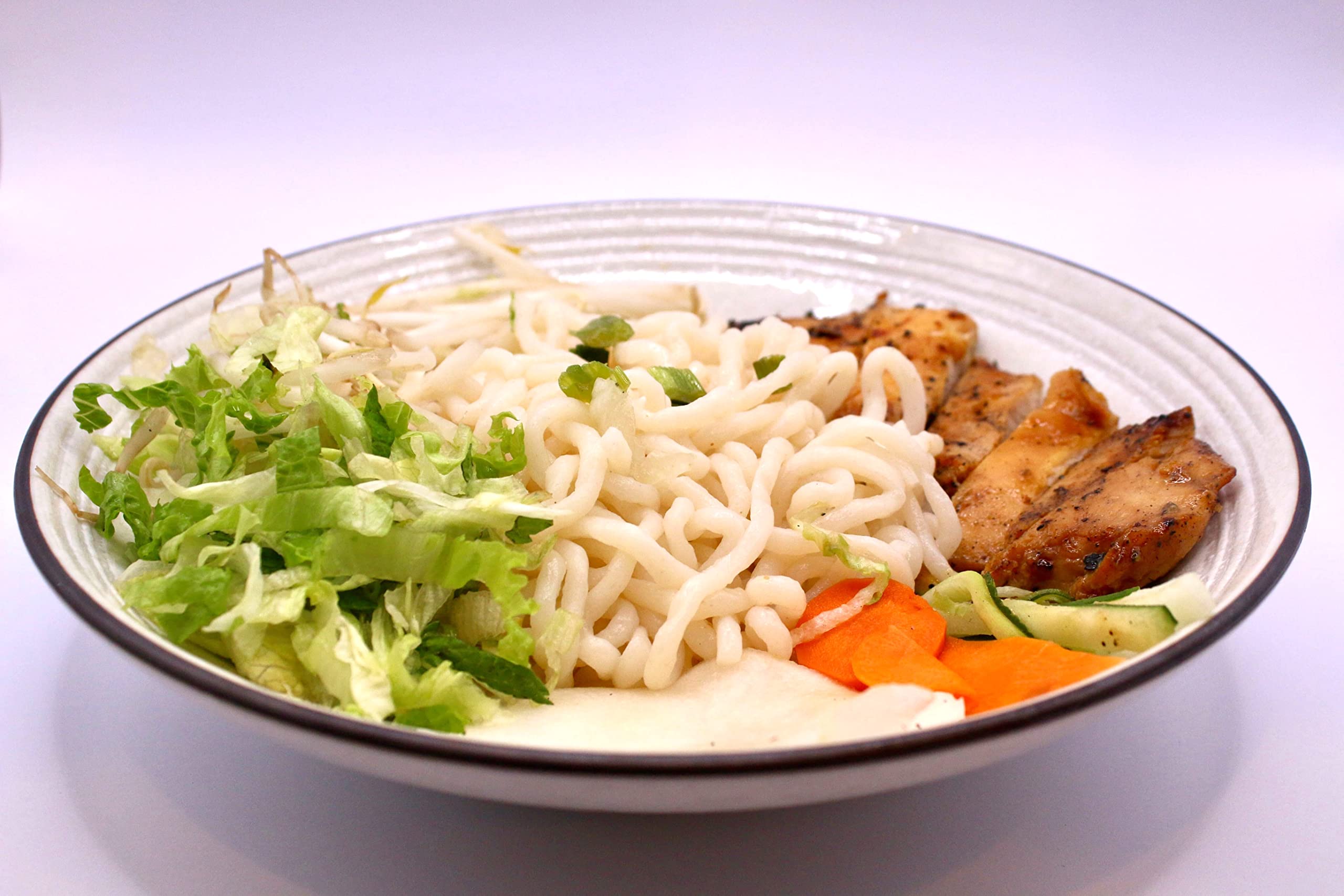 Well Lean 100 g serving beside measuring cup for portion clarity