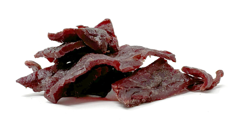 Werner close-up of jerky texture showing wood-smoked glaze and chew satisfaction