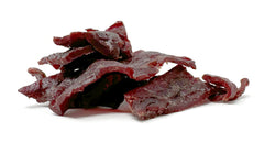 Werner close-up of jerky texture showing wood-smoked glaze and chew satisfaction