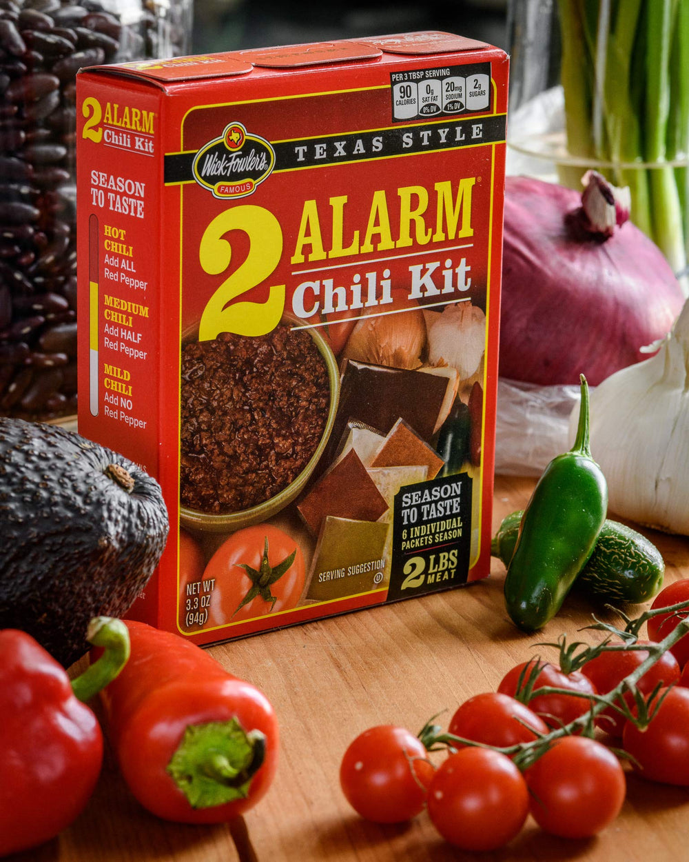 Outdoor cook serving chili using Wick Fowler's kit showing game-day convenience