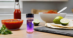 Wicked Reaper powder in white bowl highlighting color and all‑natural chili flavor