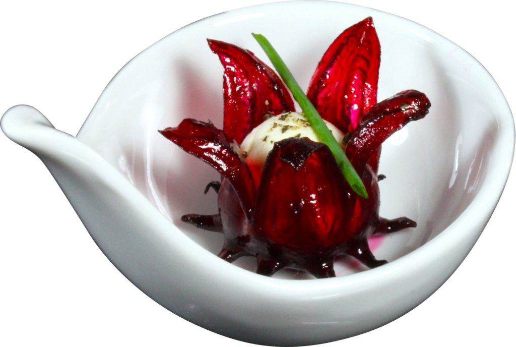 Wild Hibiscus syrup being poured from jar adding sweet floral flavor
