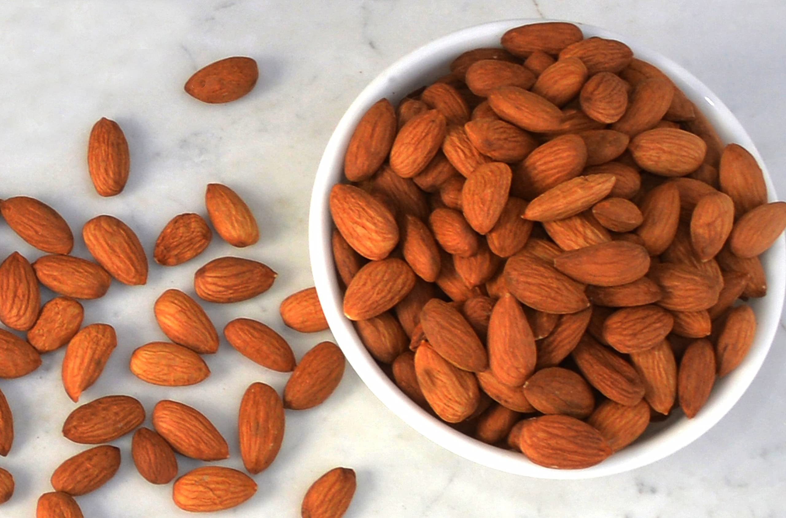 Wild Soil almonds beside a ruler and bag to show actual size and resealable packaging