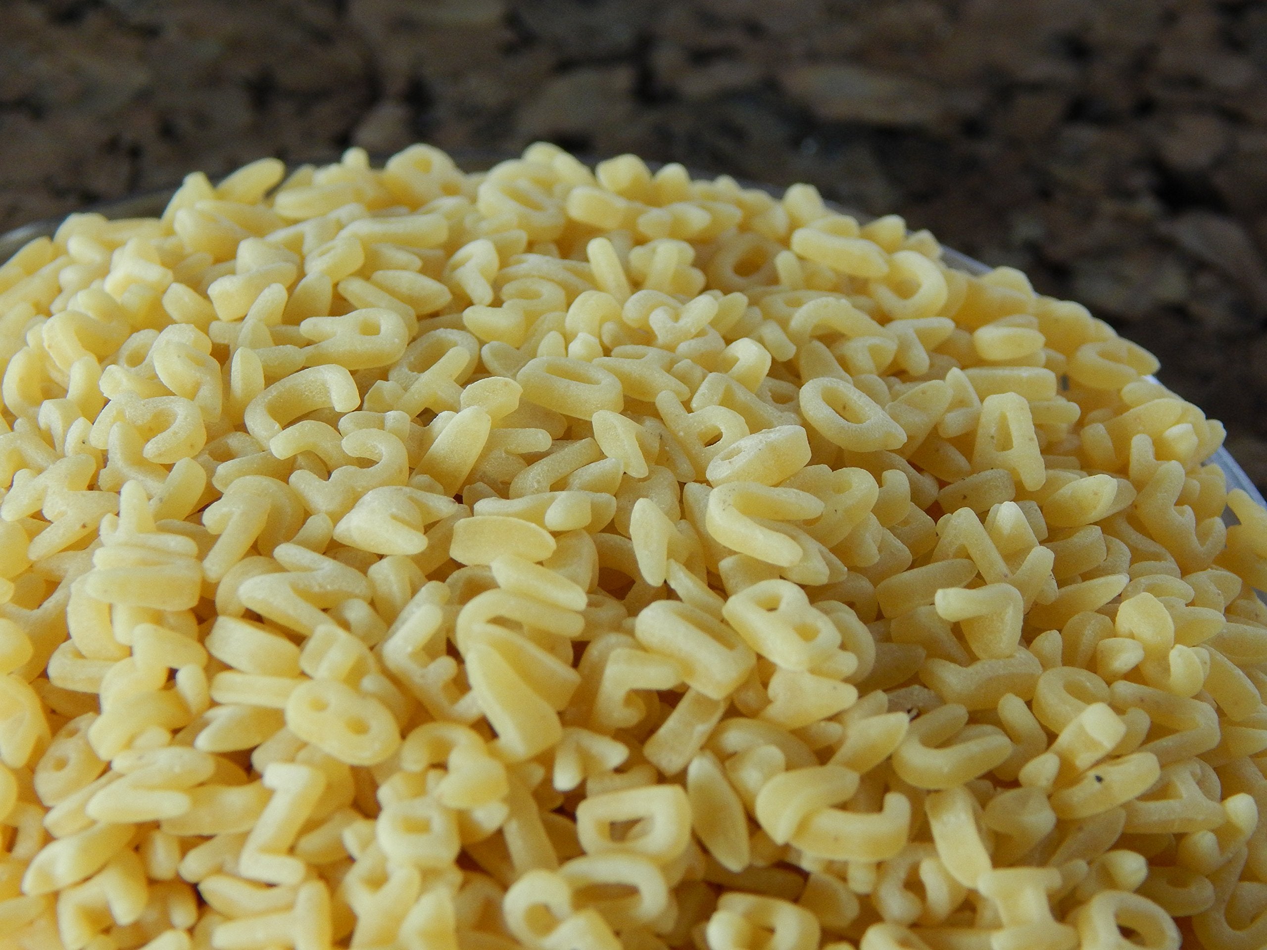 WinCrest Bulk Foods close-up of alphabet pasta letters highlighting texture and quick cook benefits