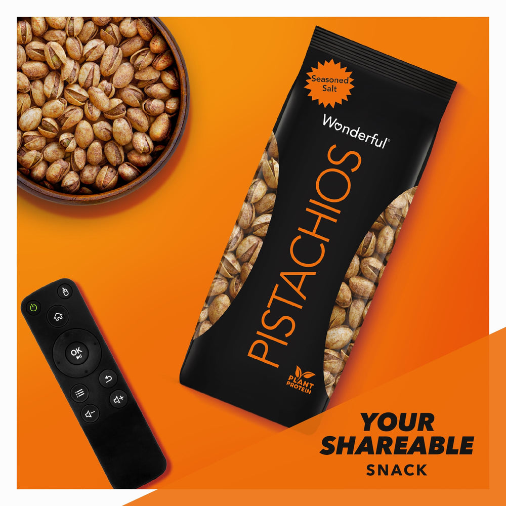 Wonderful Pistachios held in hand for scale showing 14-ounce portion and portable snack benefit