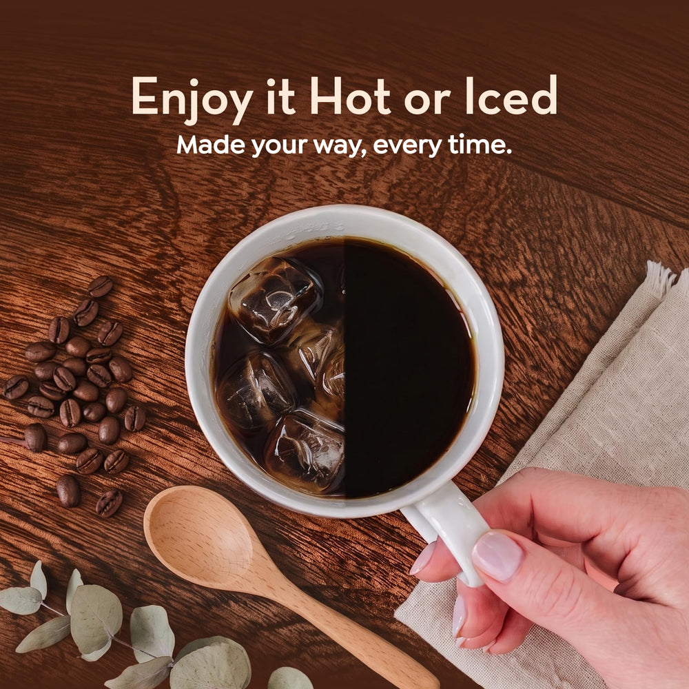 World's Best Half Caff pod beside standard coffee cup showing single-serve portion scale