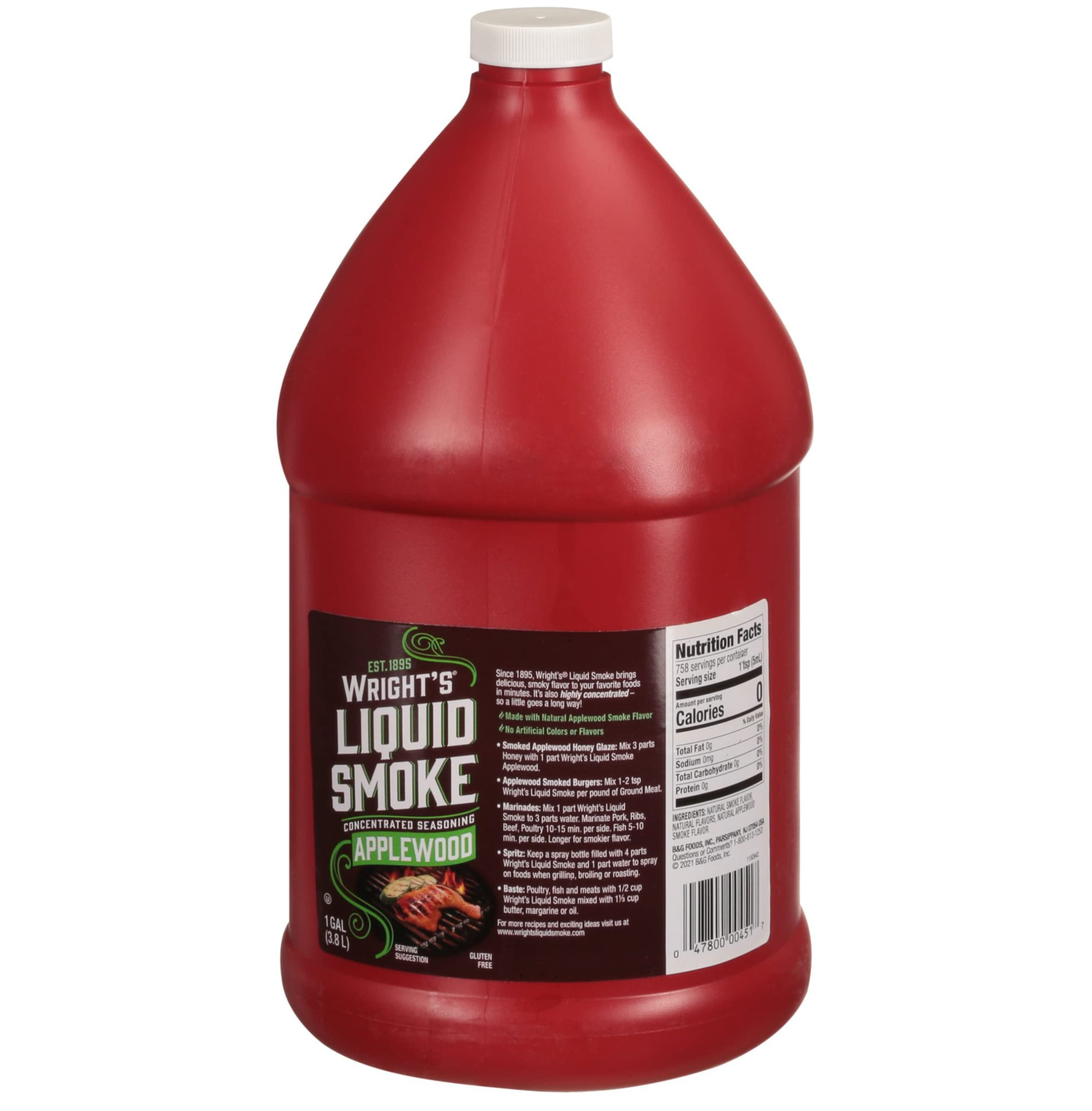 Wright's Liquid Smoke applewood pouring into a spoon to measure smoky flavor precisely