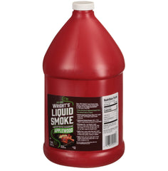 Wright's Liquid Smoke applewood pouring into a spoon to measure smoky flavor precisely