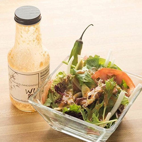 WU DRESSING drizzled on mixed greens demonstrating versatile salad use