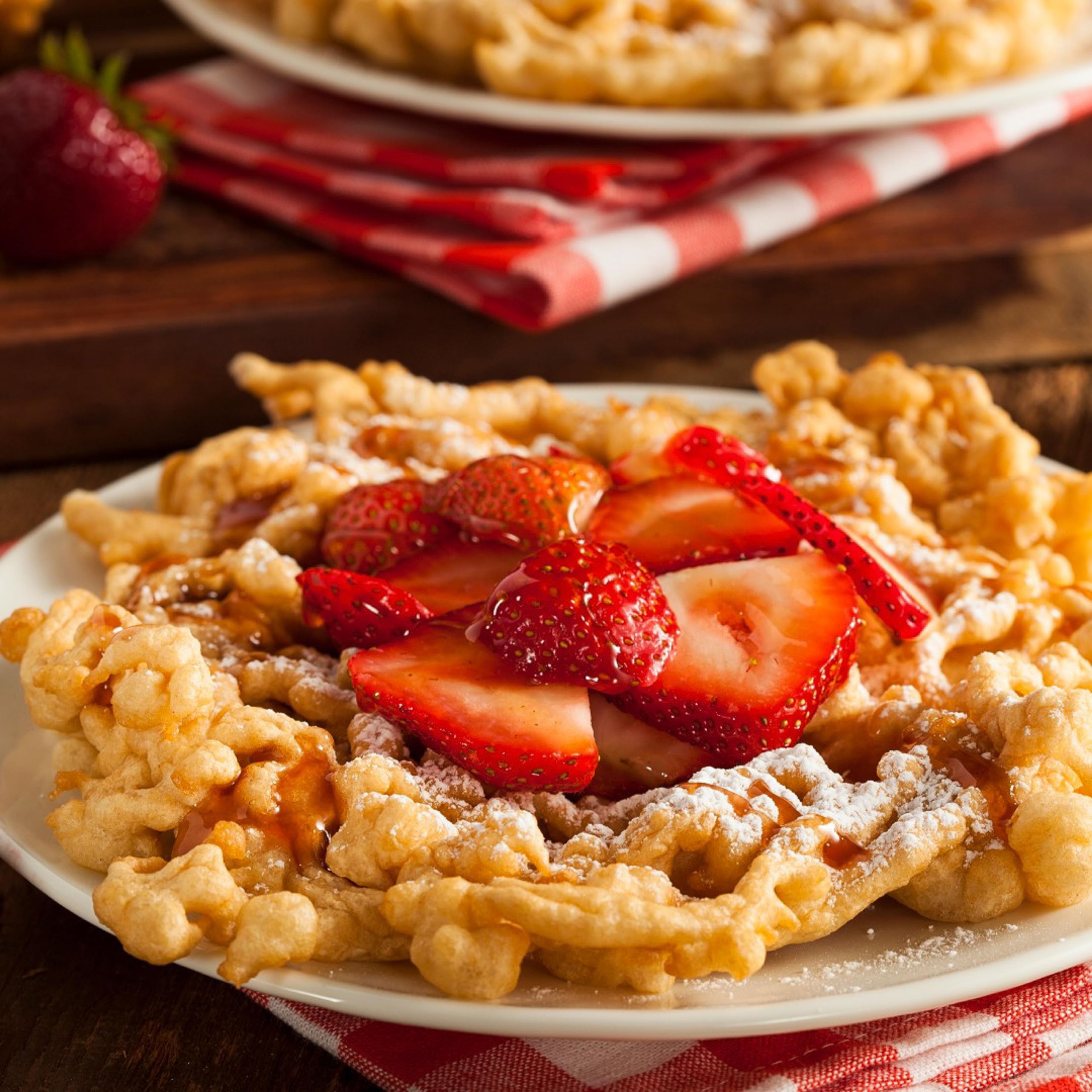 Xcell International golden fried funnel cake top view highlighting crisp edges and fluffy center