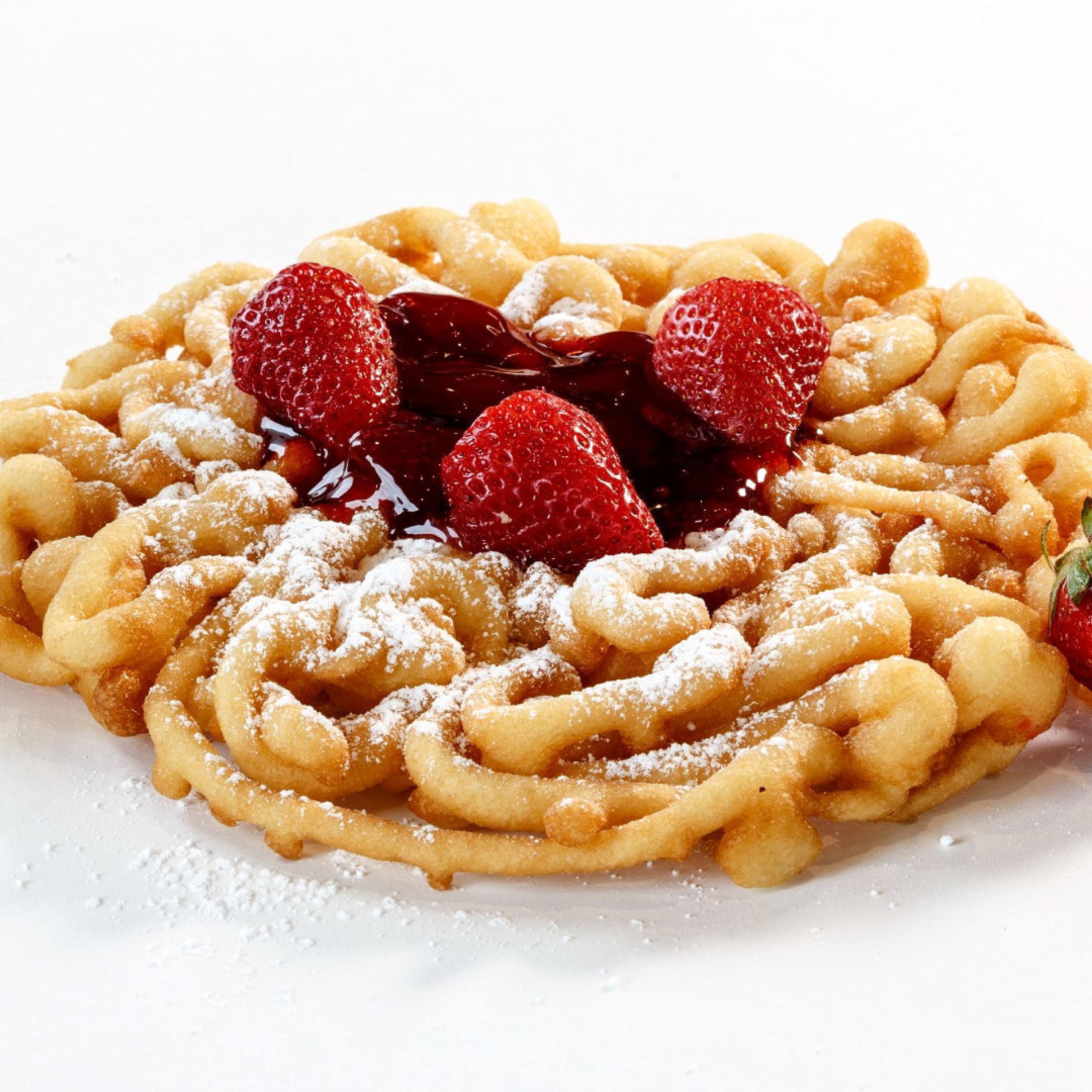Xcell International pack beside a finished funnel cake to illustrate yield and portion sizes