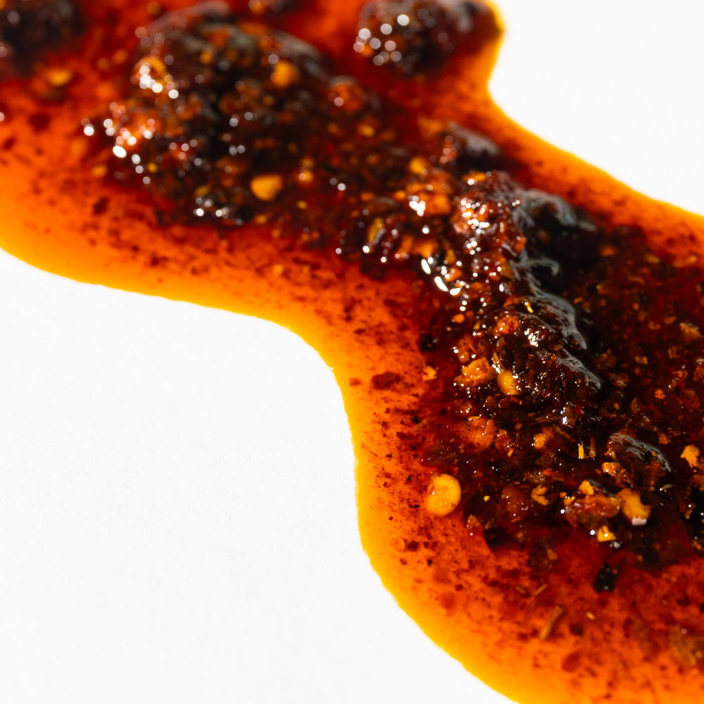 XI'AN FAMOUS FOODS spoonful of chili crisp showing balanced heat and crunch benefit