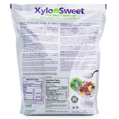 Xlear XyloSweet scoop in hand demonstrating easy pouring and measured convenience