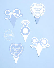xo, Fetti toppers inserted in frosted cupcakes creating instant party flair